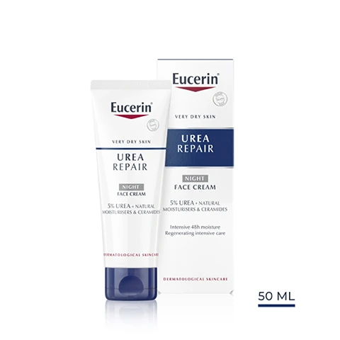 Image 1 - A tube of Eucerin Urea Repair Night Face Cream alongside its packaged box, both featuring blue and white branding, with visible text stating 5% UREA, NIGHT FACE CREAM, very dry skin, and dermatological skincare, and the box size labeled as 50 ML.
Image 2 - A close-up of a woman’s face with cream applied to her cheek, accompanied by text that lists key benefits: intensive 48h moisture, regenerating intensive care, and reduces skin tightness.
Image 3 - A hand holds a tube of Eucerin Urea Repair cream on the left, with text on the right stating Dry, tense, dehydrated skin, For face, and Night.
Image 4 - A smooth, white cream blob with labels pointing to its key ingredients: 5% Urea, Ceramides, and Natural Moisturisers.
Image 5 - Image features a blue background with the following text: Clinically proven Improves skins moisture and barrier function.
Image 6 - Image shows three skincare products from Eucerin labeled as part of a recommended routine, with a lip balm on the left labeled as LIP CARE, a tube of day cream in the center labeled as DAY CREAM, and a tube of night cream on the right labeled as NIGHT CREAM, all under the heading Recommended Routine.