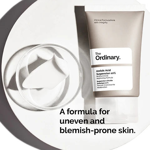 Image 1 - A tube of The Ordinary Azelaic Acid Suspension 10% is placed beside a small dish containing a cream, with text at the bottom reading A formula for uneven and blemish-prone skin.
Image 2 - A woman gently applies a cream-like substance to her cheek, with visible text that reads Cream-like texture and 10% Azelaic Acid brightens skin tone and noticeably improves skin texture.
Image 3 - A smooth, white surface with curved lines and visible text that reads Apply daily in the morning and evening. Use sun protection during the day.
Image 4 - Image showing three categories of skincare products labeled as PREP, TREAT, and SEAL with corresponding product types: cleansers and toners under PREP, water-based serums, eye serums, anhydrous solutions, and oils under TREAT, and suspensions, moisturizers, and SPF under SEAL.