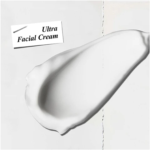 Image 1 - A smooth, white cream is spread on a surface with a label above reading Ultra Facial Cream.
Image 2 - A person with dark skin is applying a white cream on their cheek, with one hand holding the cream and the other pointing at it; visible text reads HYDRATING Moisturiser.
Image 3 - The image features a bright blue background with an inset photo of crystalline ice, surrounded by ice fragments, and the text includes Our Formula With: Glacial Glycoprotein Squalane.
Image 4 - An image of a Kiehls Ultra Facial Cream jar with a refill pouch positioned above it, a message on the left side reads NOW REFILLABLE REUSE, REFILL.
Image 5 - A flat lay of Kiehls skincare products featuring a box labeled Kiehls containing a hydration refill packet and a jar of Ultra Facial Cream, accompanied by a note that reads Give the gift of sustainable hydration.