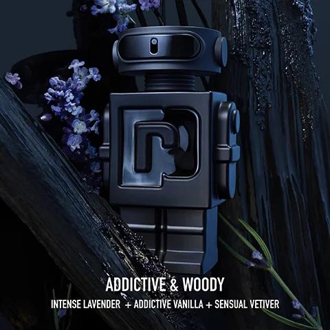 A dark, robotic-shaped perfume bottle with an R logo stands among dark wood and purple lavender flowers, with text that reads ADDITIVE & WOODY INTENSE LAVENDER + ADDICTIVE VANILLA + SENSUAL VETIVER.